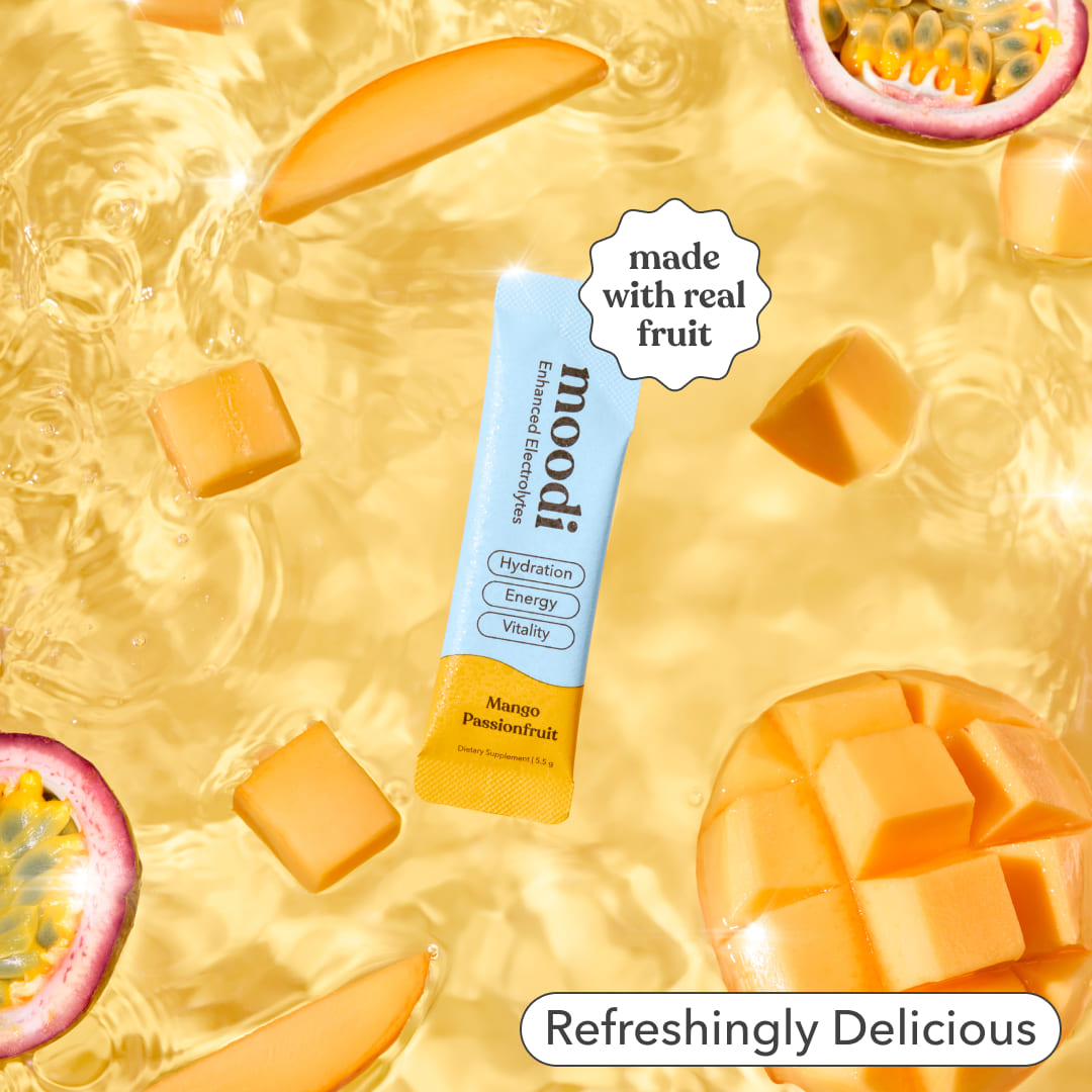 Moodi Mango Passionfruit Enhanced Electrolyte sachet with mango and passionfruit on a yellow background with text 'made with real fruit' and 'refreshingly delicious'
