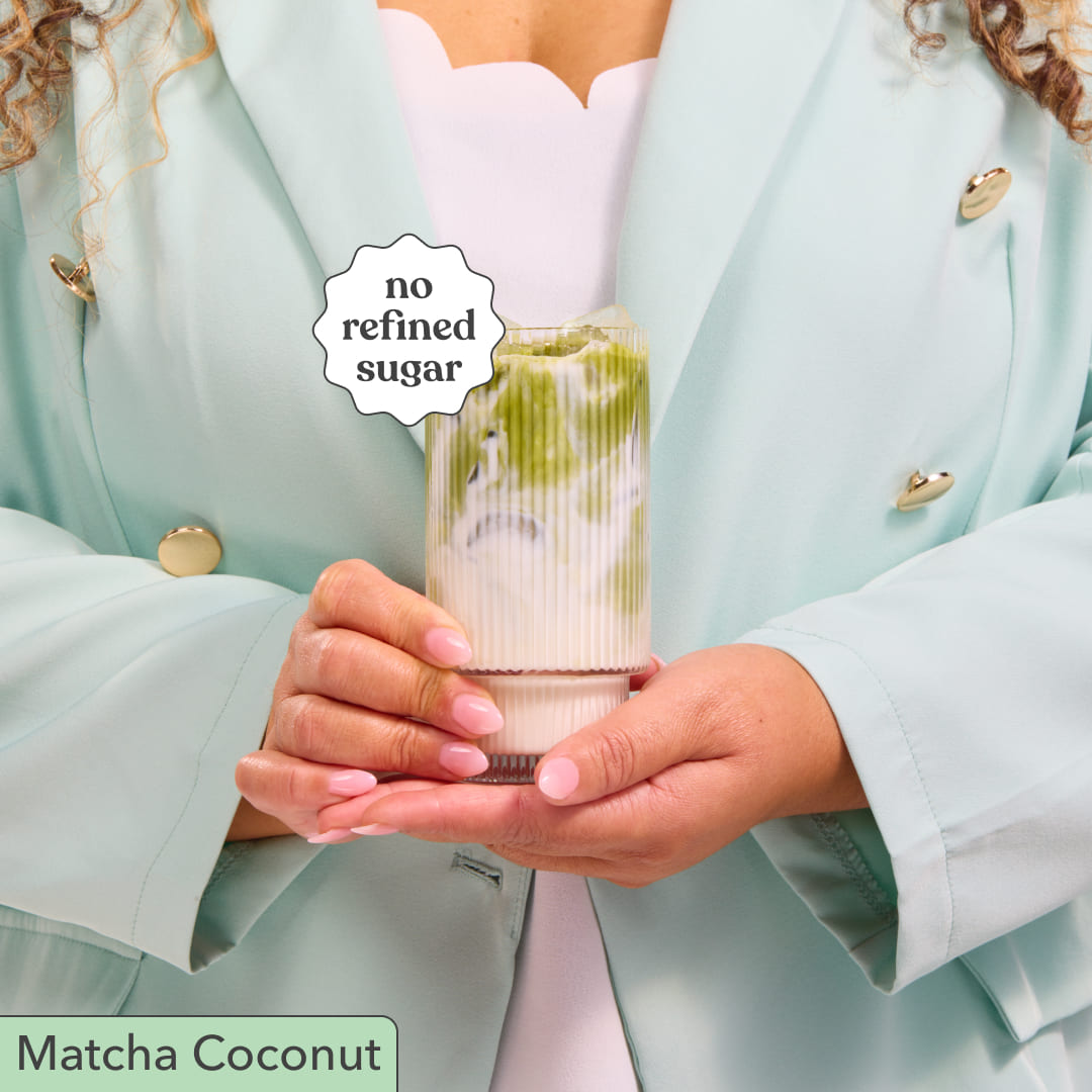 Person holding Moodi Matcha Coconut with a 'no refined sugar' label