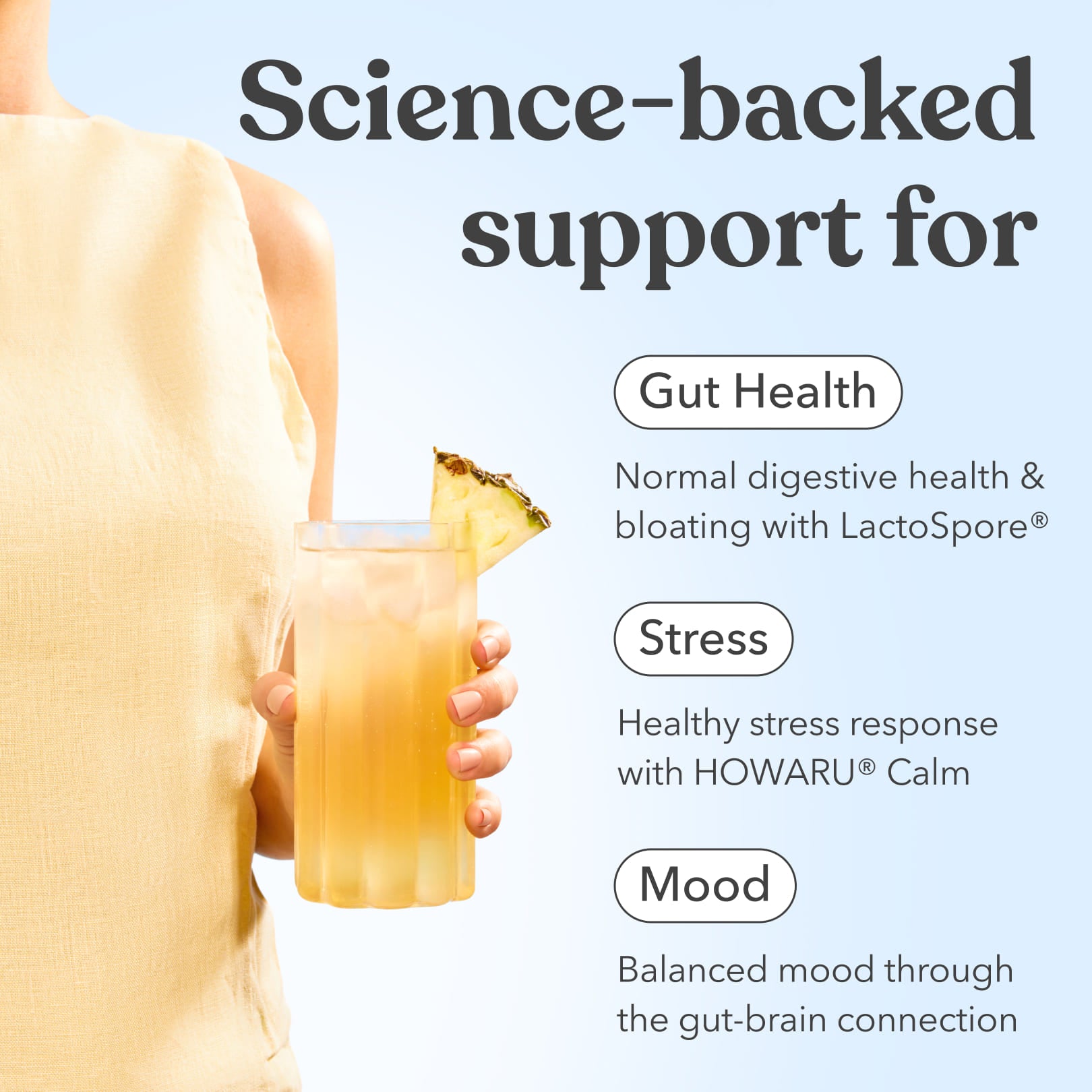 Person holding Moodi Tropicana drink in a glass with text promoting gut health, stress and mood support on a light blue background.