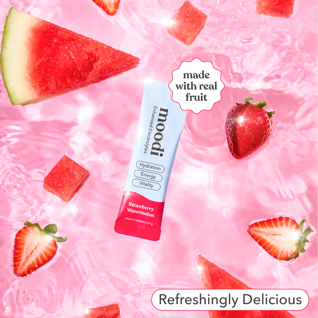 Moodi Strawberry Watermelon Enhanced Electrolyte sachet with strawberry and watermelon slices on a pink background, with text 'made with real fruit' and 'refreshingly delicious'