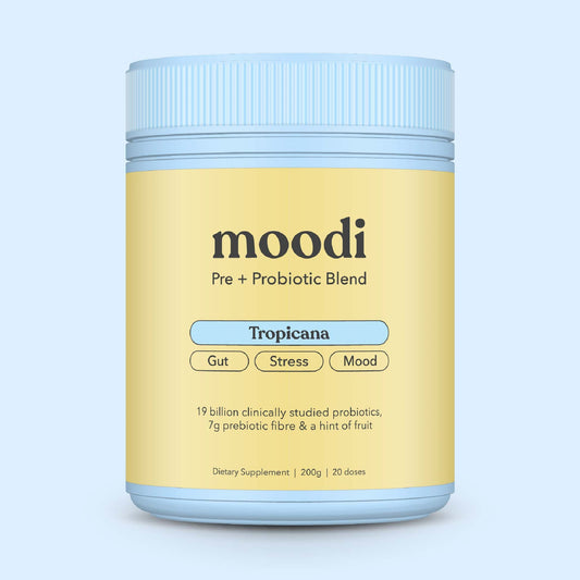 Container of moodi Pre + Probiotic Blend on a light blue background