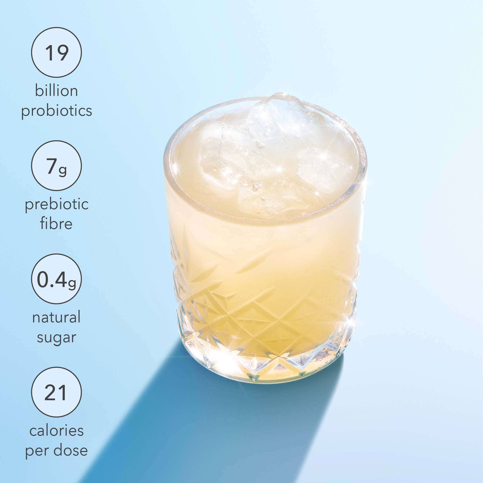 Glass of a probiotic drink with nutritional information on a light blue background