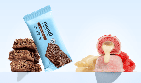 Moodi Double Choc Protein Crisp Bar and Raspberry White Choc Plant Protein Ball with their filled centre and crispy texture visible