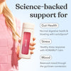 Person holding Moodi's drink bottle with Pink Lemonade, with text promoting gut health, stress and mood support on a light blue background.