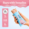 Hand holding a protein bar with nutritional information displayed on a pink and blue background