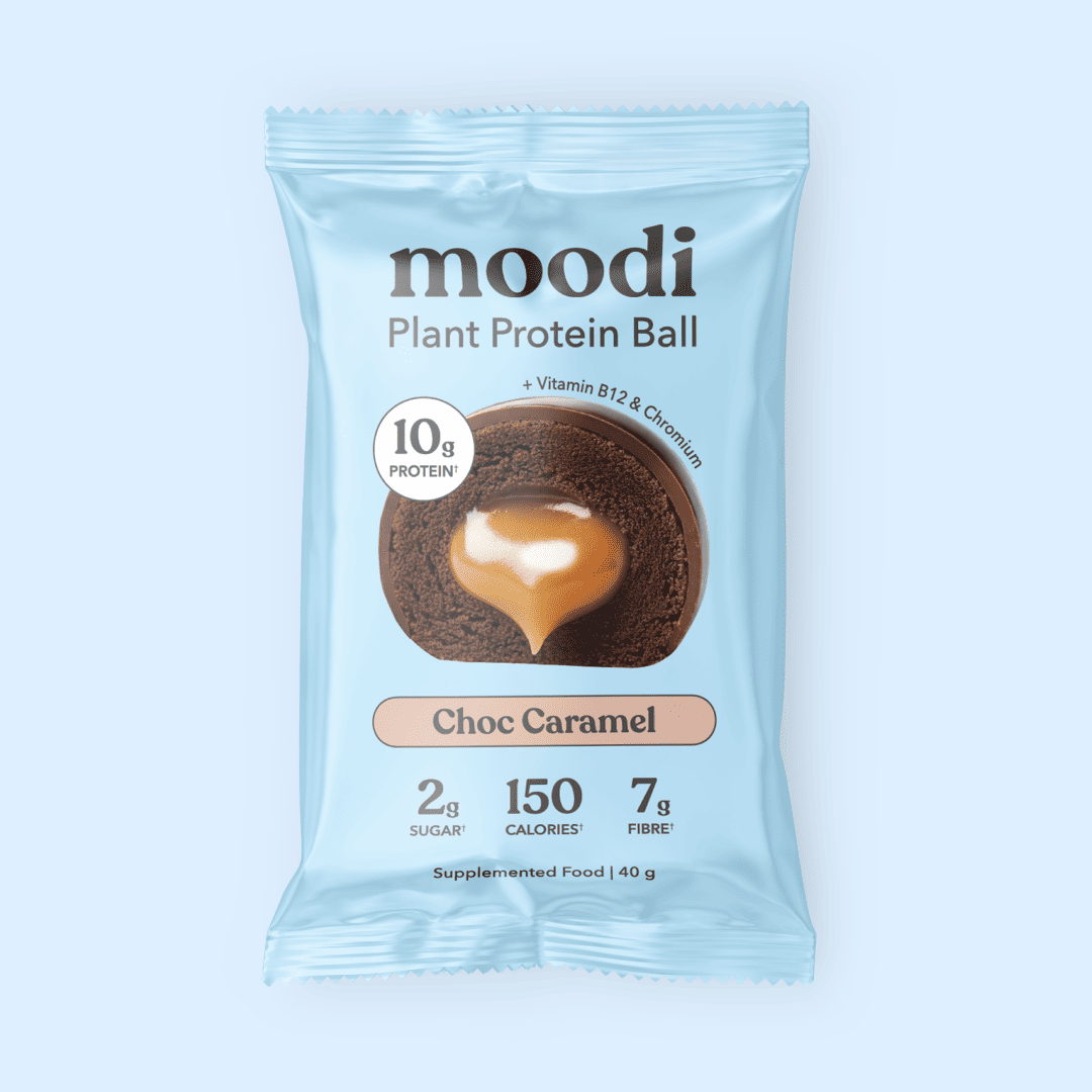 Moodi Choc Caramel Plant Protein Ball packaging on a light blue background