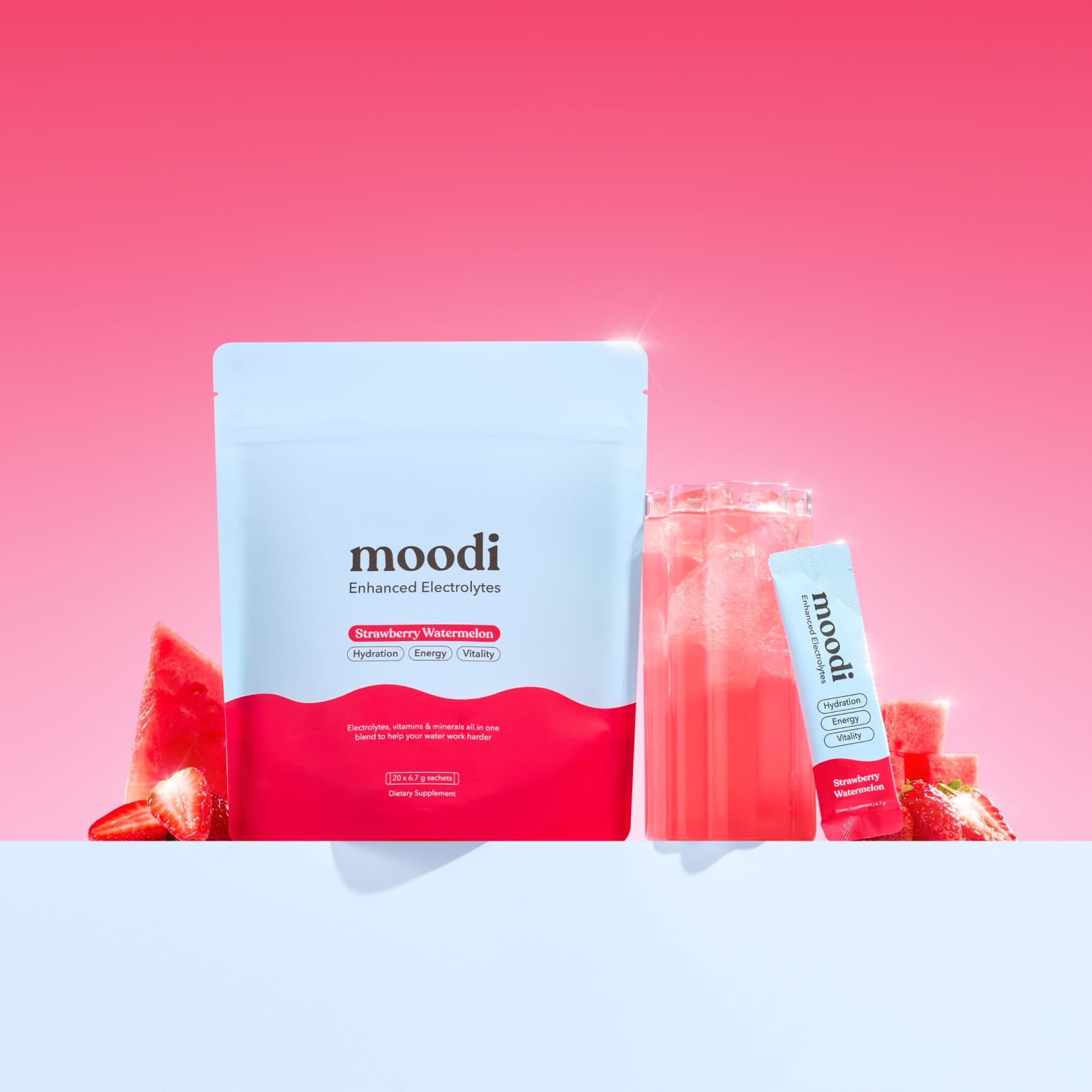 Moodi Strawberry Watermelon Enhanced Electrolyte pouch and sachet with drink and fruit slices on a pink background