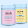 Two jars of moodi pre + probiotic blend, one pink lemonade and one tropicana, on a light blue background.