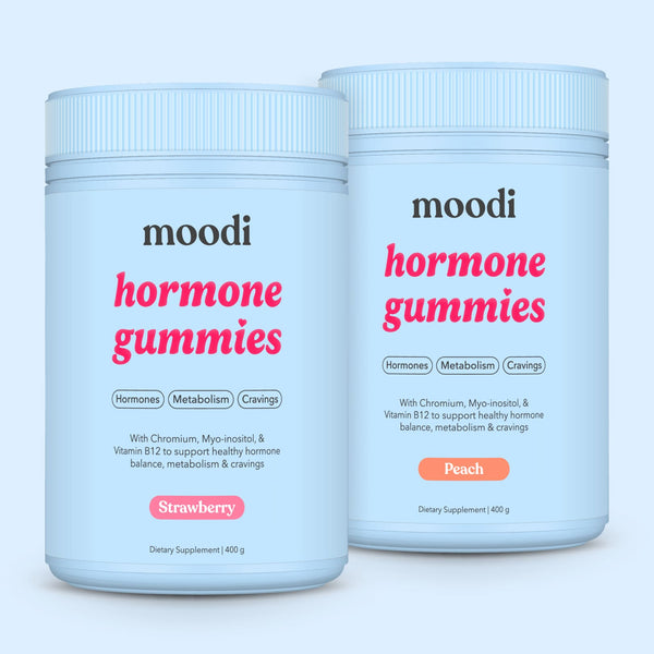 Moodi strawberry and peach hormone gummies tubs on a light blue background