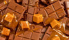 Pile of chocolate bars with caramel cubes and drizzle