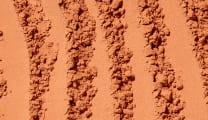 Close-up of textured brown powder with patterns