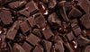 Close-up of dark chocolate pieces with drizzle