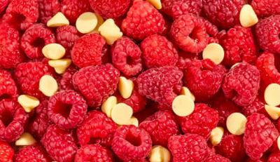 Close-up of raspberries and white chocolate buttons