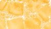 Close-up of ice cubes in sparkling Moodi Tropicana drink with visible bubbles
