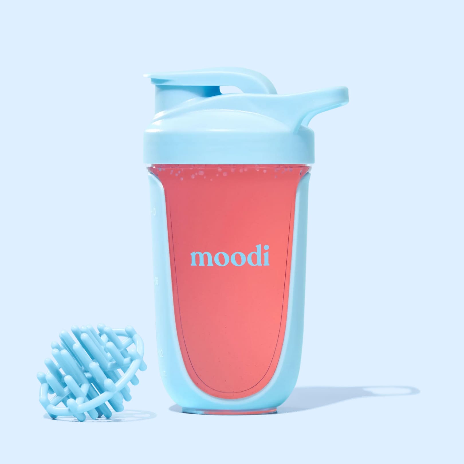 Light blue Moodi shaker filled with pink liquid with shaker ball